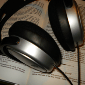 Headphones resting on a book - Writers' Christmas gift guide